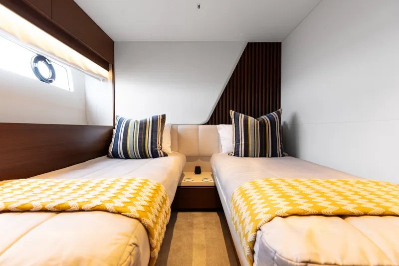 Slide: The Image of Luxurious twin cabin on 2021 Princess Y85 yacht with striped pillows and yellow blankets. - 52