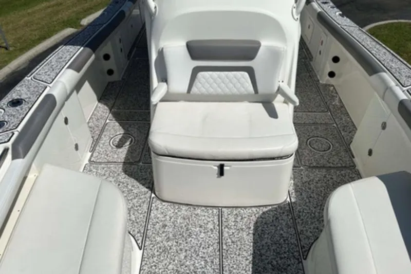 Slide: The Image of 2018 World Cat 320 CC boat interior with cushioned seating and spacious deck. - 15