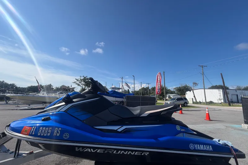 Slide: The Image of 2018 Yamaha WaveRunner EX Deluxe in blue, parked outdoors under a clear sky. - 6