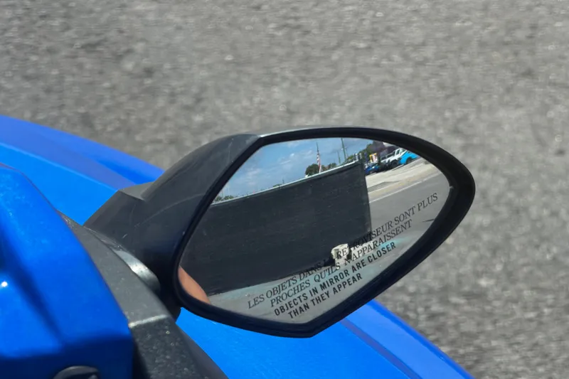 Slide: The Image of Side mirror view on a 2018 Yamaha WaveRunner EX Deluxe, reflecting nearby vehicles. - 20