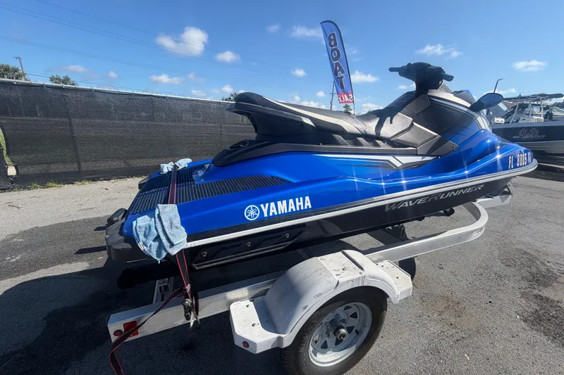 Slide: The Image of 2018 Yamaha WaveRunner EX Deluxe on trailer under clear blue sky. - 2