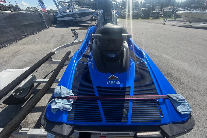 Slide: The Image of 2018 Yamaha WaveRunner EX Deluxe in blue, parked on a trailer at a marina. - 3