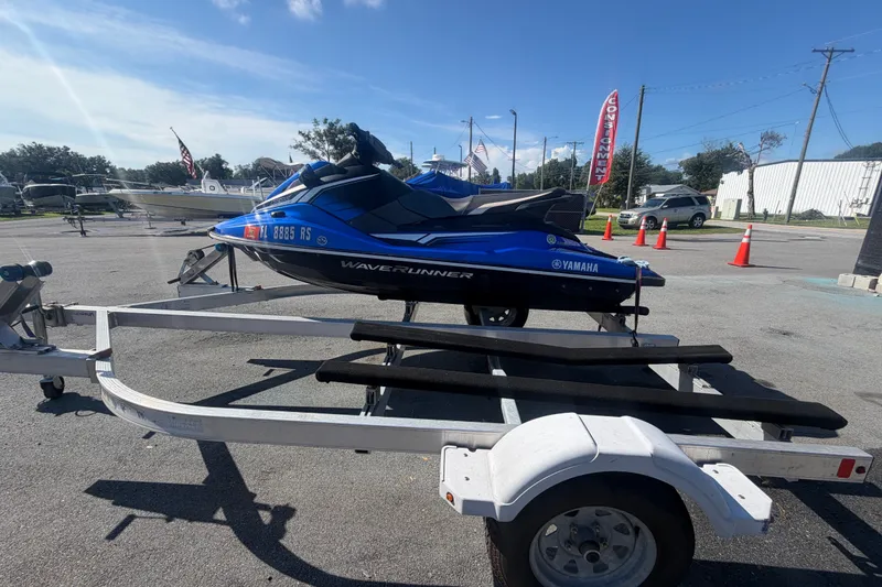 Slide: The Image of 2018 Yamaha WaveRunner EX Deluxe on trailer, parked outdoors under clear sky. - 5
