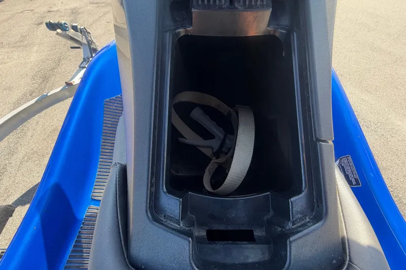 Slide: The Image of A blue 2018 Yamaha WaveRunner EX Deluxe with an open storage compartment containing a strap. - 17