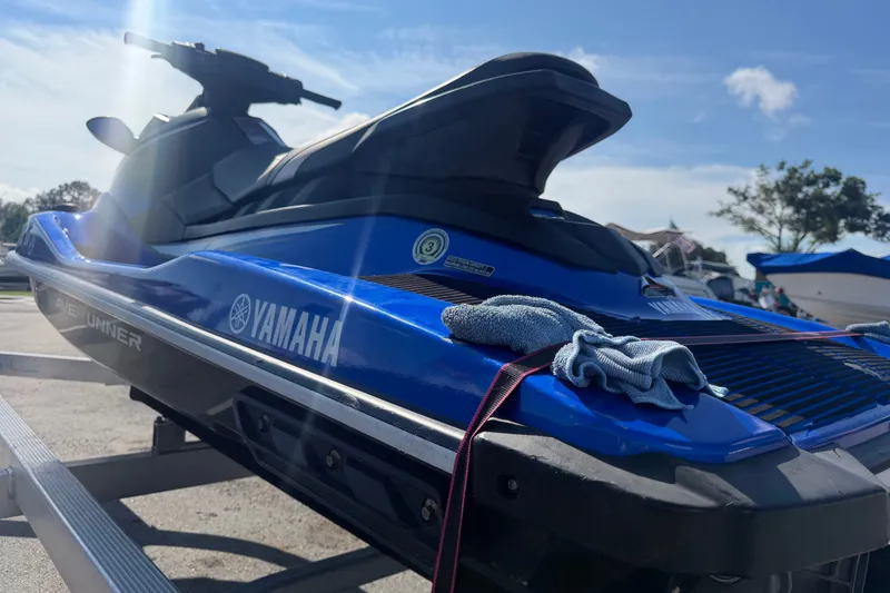 Slide: The Image of 2018 Yamaha WaveRunner EX Deluxe on trailer under clear blue sky. - 31