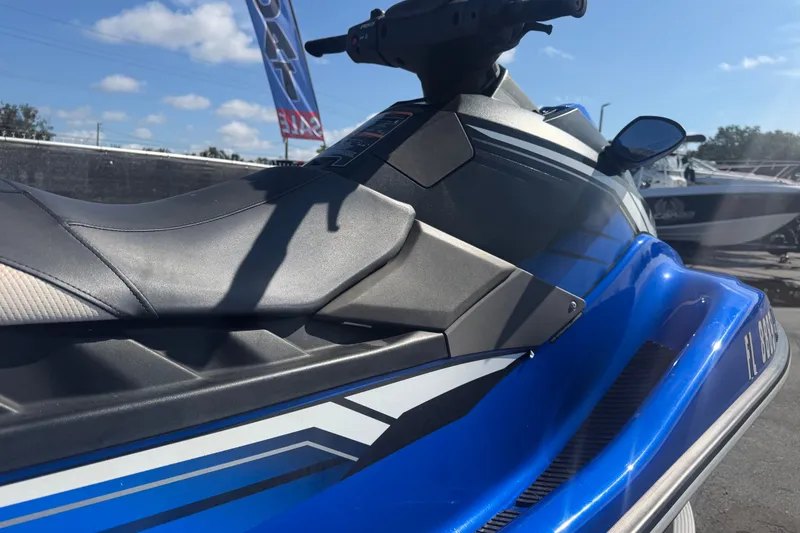 Slide: The Image of 2018 Yamaha WaveRunner EX Deluxe in blue, parked outdoors under a clear sky. - 33