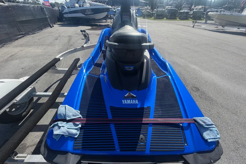Slide: The Image of 2018 Yamaha WaveRunner EX Deluxe in blue on a trailer at a marina. - 12