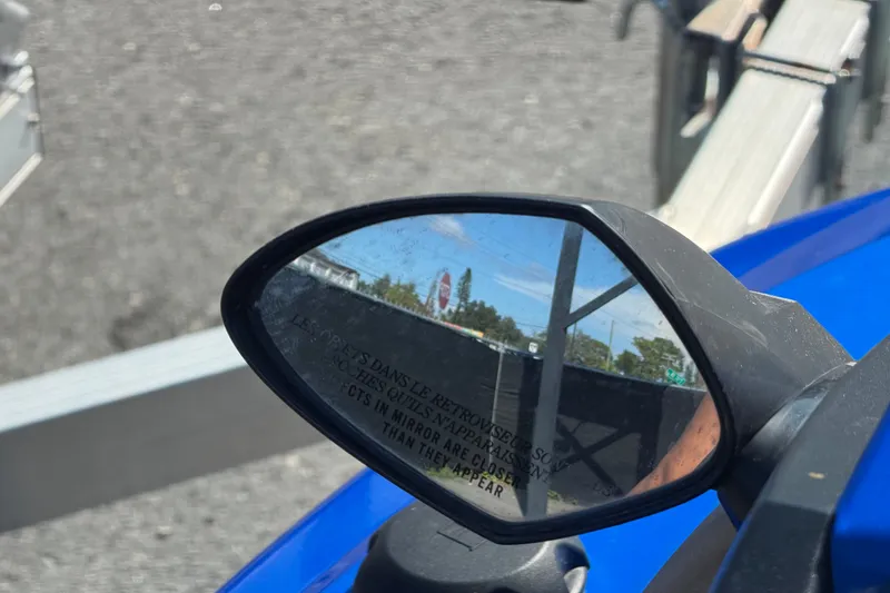 Slide: The Image of Side mirror view on a 2018 Yamaha WaveRunner EX Deluxe, reflecting a clear sky and trees. - 21