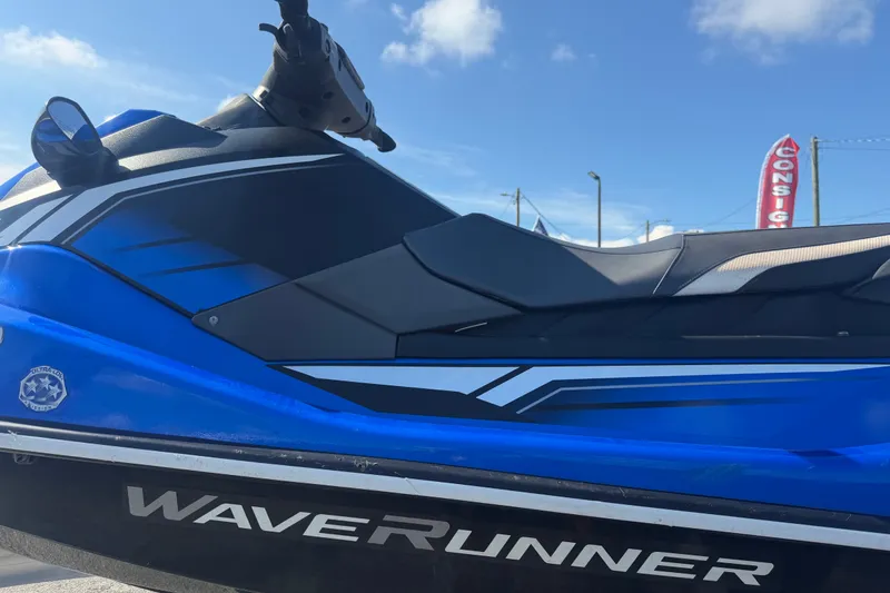 Slide: The Image of 2018 Yamaha WaveRunner EX Deluxe in blue, side view under clear sky. - 30