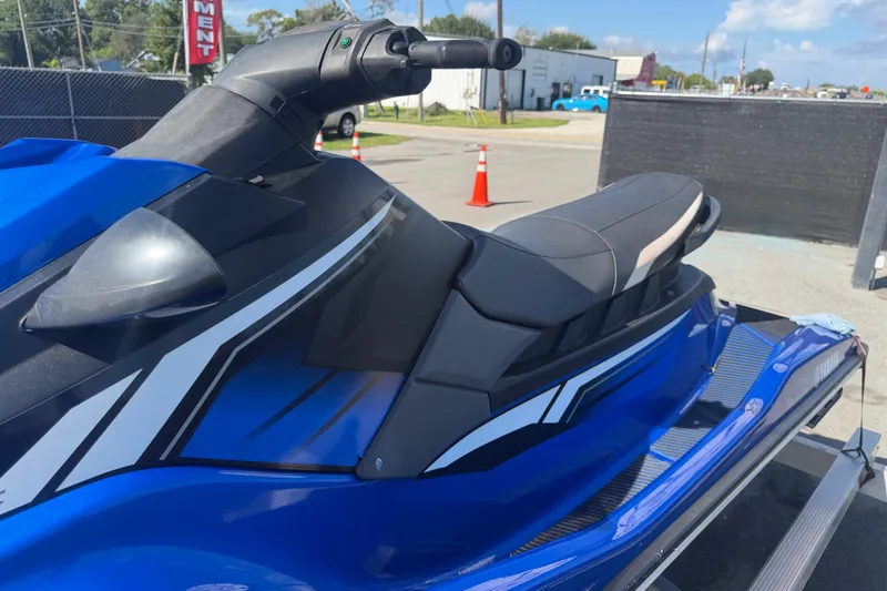 Slide: The Image of 2018 Yamaha WaveRunner EX Deluxe in blue, parked on a trailer outdoors. - 29