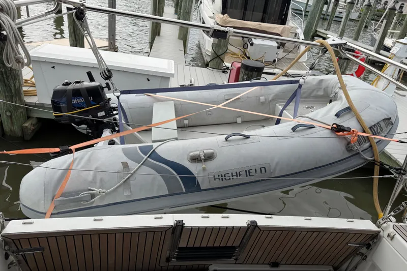 Slide: The Image of Inflatable dinghy secured on Jeanneau Sun Odyssey 490, 2020 model, at marina dock. - 27