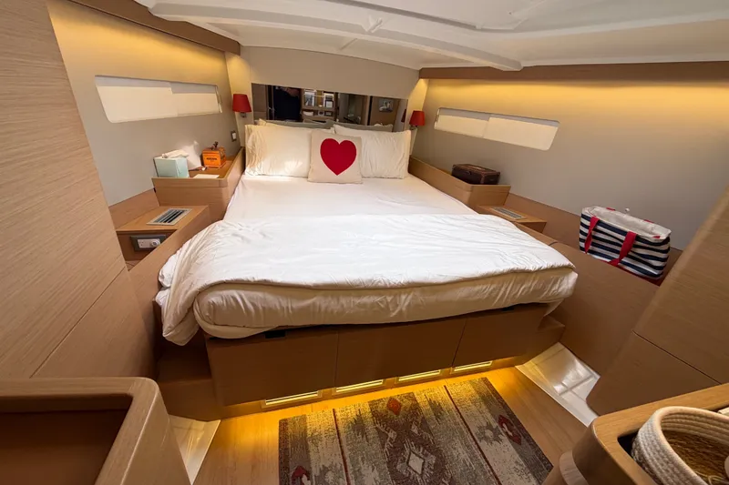 Slide: The Image of Luxurious cabin interior of 2020 Jeanneau Sun Odyssey 490 yacht with cozy bed and ambient lighting. - 19