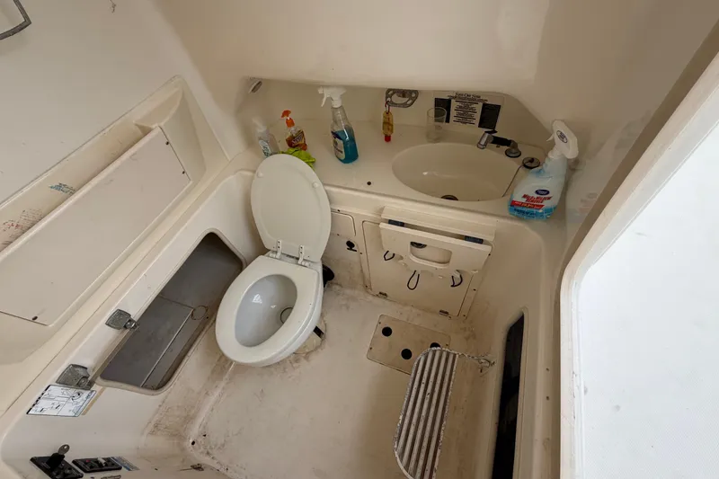 Slide: The Image of Interior of 2007 Boston Whaler 320 Outrage boat bathroom with toilet and sink. - 40