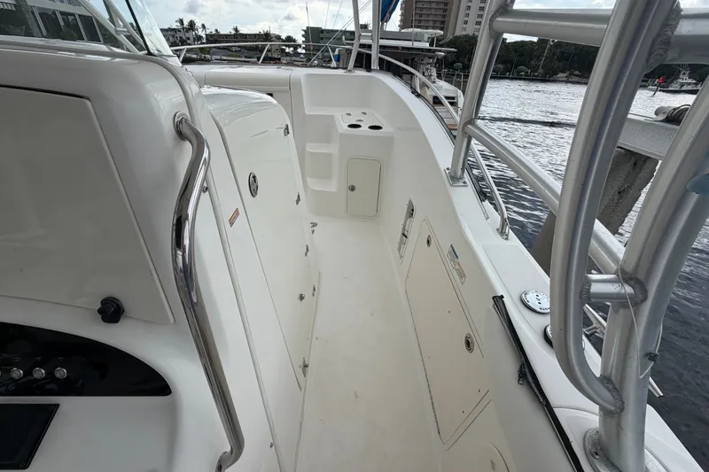 Slide: The Image of 2007 Boston Whaler 320 Outrage boat deck with railing and storage compartments. - 37