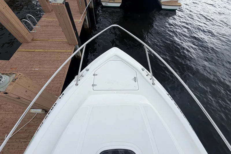 Slide: The Image of Bow view of 2007 Boston Whaler 320 Outrage docked by wooden pier. - 9
