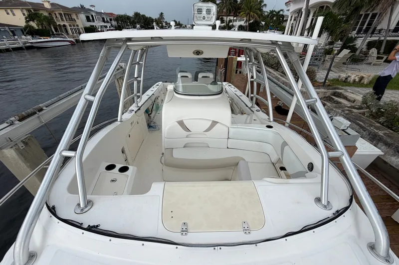 Slide: The Image of 2007 Boston Whaler 320 Outrage boat docked, featuring spacious seating and sleek design. - 13