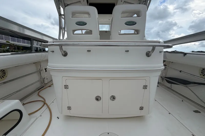 Slide: The Image of 2007 Boston Whaler 320 Outrage boat interior with seating and storage compartments. - 19