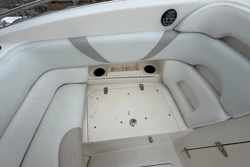 Slide: The Image of Interior seating area of a 2007 Boston Whaler 320 Outrage boat, featuring white upholstery. - 50