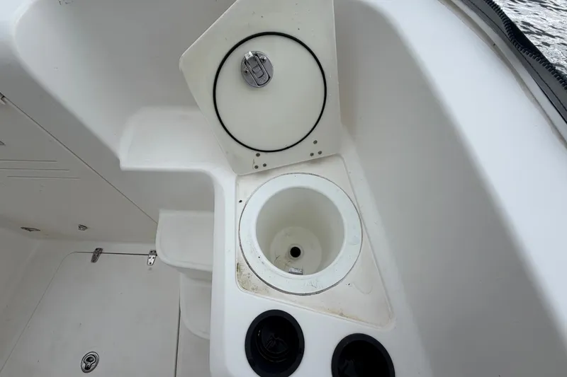 Slide: The Image of 2007 Boston Whaler 320 Outrage boat interior with storage compartment and cup holders. - 47