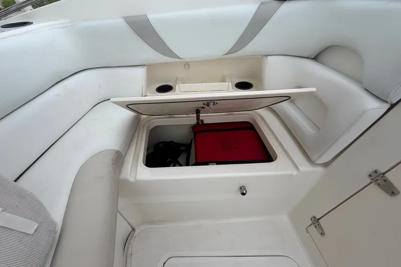 Slide: The Image of 2007 Boston Whaler 320 Outrage boat storage compartment with open hatch and seating area. - 49