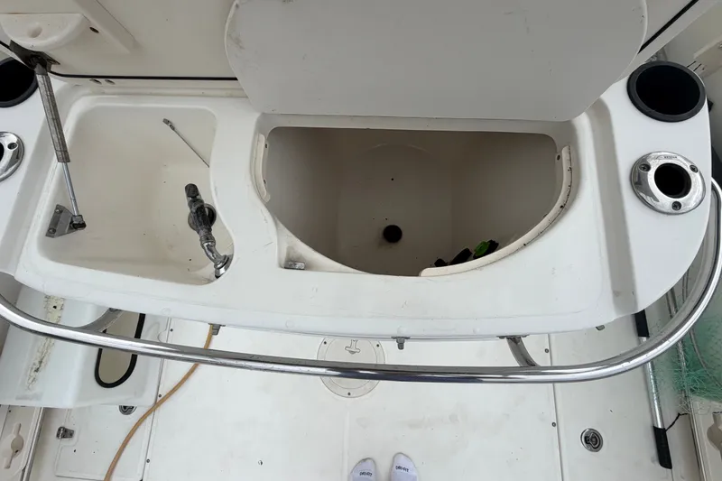 Slide: The Image of 2007 Boston Whaler 320 Outrage boat interior with storage compartments and railing. - 18