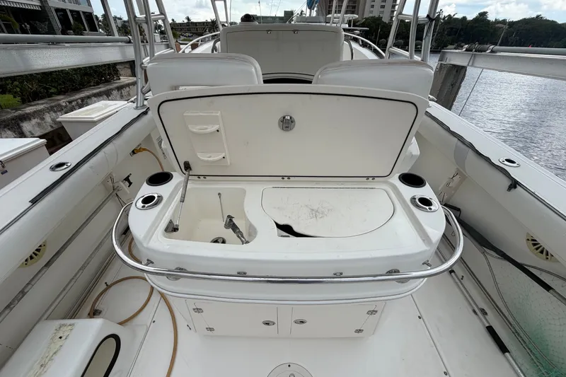 Slide: The Image of 2007 Boston Whaler 320 Outrage boat interior with open storage compartment and cup holders. - 17