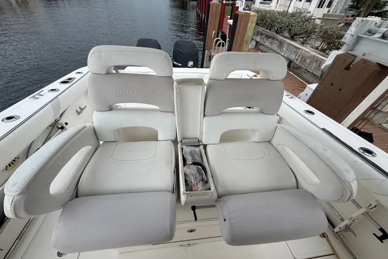 Slide: The Image of Boston Whaler 320 Outrage 2007 boat seats, white leather, docked by waterfront. - 24