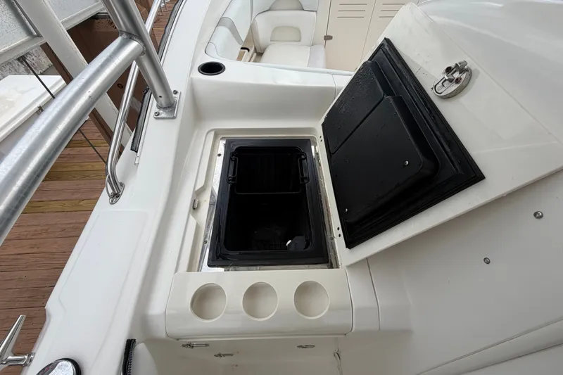 Slide: The Image of 2007 Boston Whaler 320 Outrage boat interior with open storage compartment and cup holders. - 34