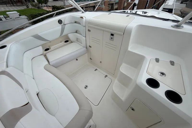 Slide: The Image of 2007 Boston Whaler 320 Outrage interior with seating, storage compartments, and cup holders. - 44
