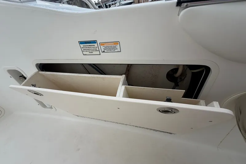 Slide: The Image of Open storage compartment on a 2007 Boston Whaler 320 Outrage boat interior. - 42