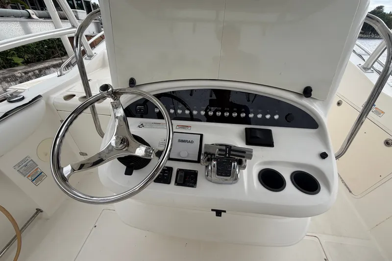 Slide: The Image of 2007 Boston Whaler 320 Outrage helm with steering wheel and control panel. - 26