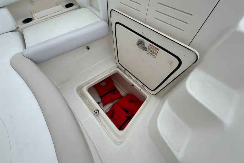 Slide: The Image of Storage compartment with life jackets on a 2007 Boston Whaler 320 Outrage boat. - 51