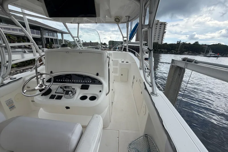 Slide: The Image of 2007 Boston Whaler 320 Outrage boat interior with steering wheel and control panel. - 36