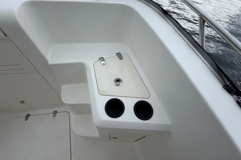 Slide: The Image of 2007 Boston Whaler 320 Outrage boat interior with storage compartment and cup holders. - 46