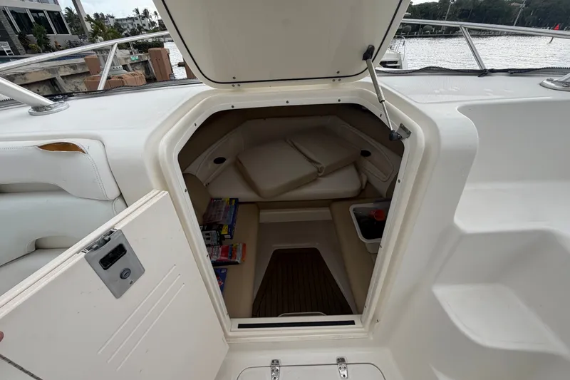 Slide: The Image of 2007 Boston Whaler 320 Outrage cabin interior with storage and seating area. - 53