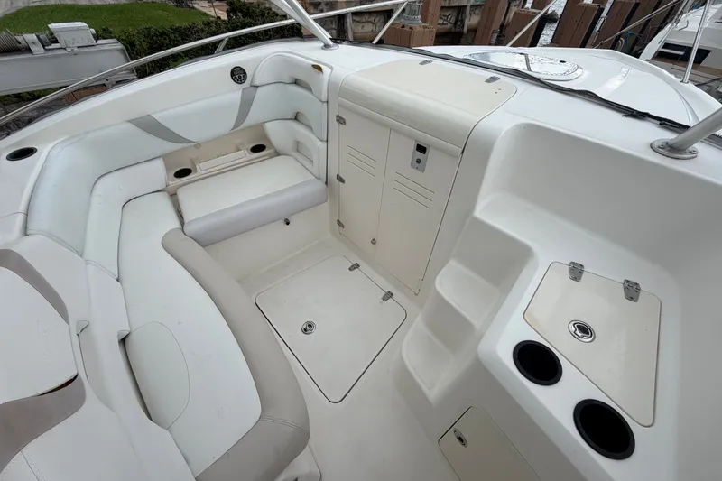 Slide: The Image of 2007 Boston Whaler 320 Outrage interior with seating, storage, and cup holders. - 48