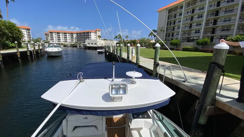 Slide: The Image of 2015 Monterey 295 Sport Yacht docked in a sunny marina with waterfront buildings. - 16