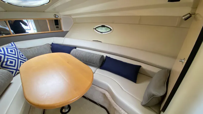 Slide: The Image of Interior of 2015 Monterey 295 Sport Yacht with cozy seating and wooden table. - 29