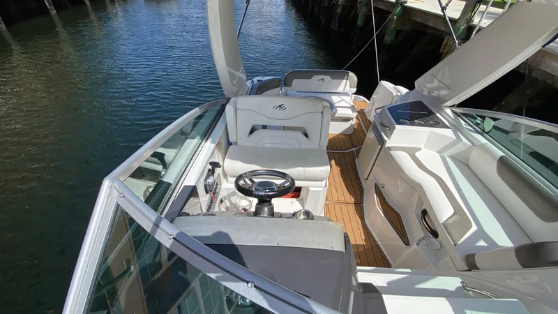 Slide: The Image of 2015 Monterey 295 Sport Yacht interior with helm, seating, and deck view. - 14