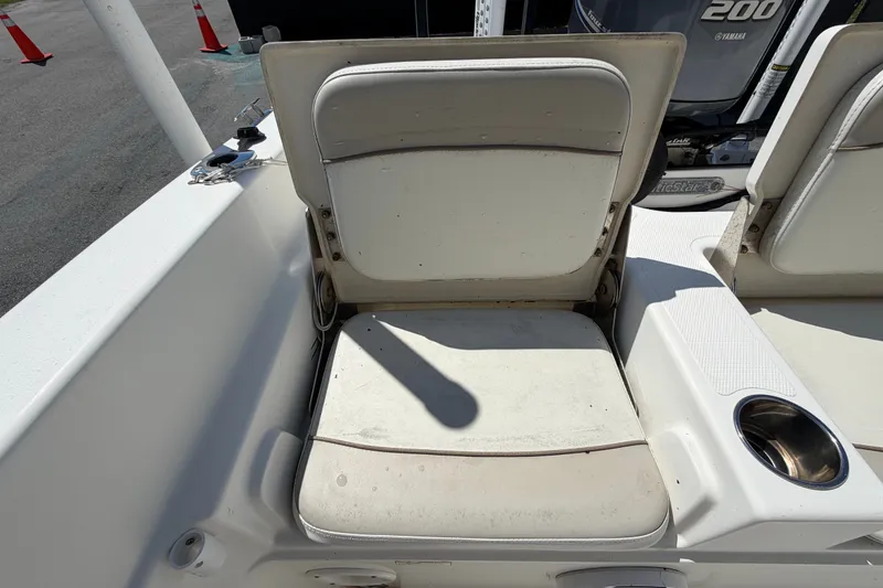 Slide: The Image of 2015 NauticStar 231 Coastal boat seat with cup holder and Yamaha engine in background. - 61
