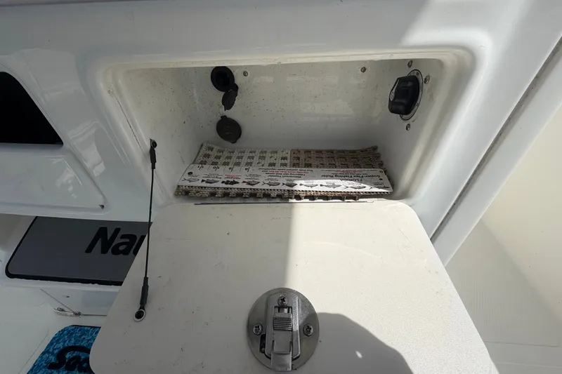 Slide: The Image of Un compartiment de rangement ouvert sur un bateau avec un tapis antidérapant et des prises électriques. - 20
