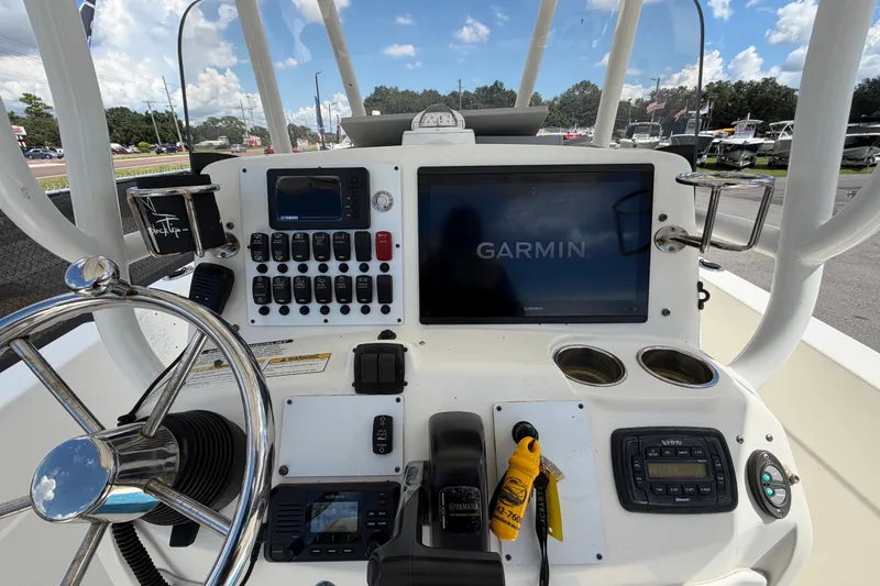 Slide: The Image of 2015 NauticStar 231 Coastal boat dashboard with Garmin navigation system and controls. - 23