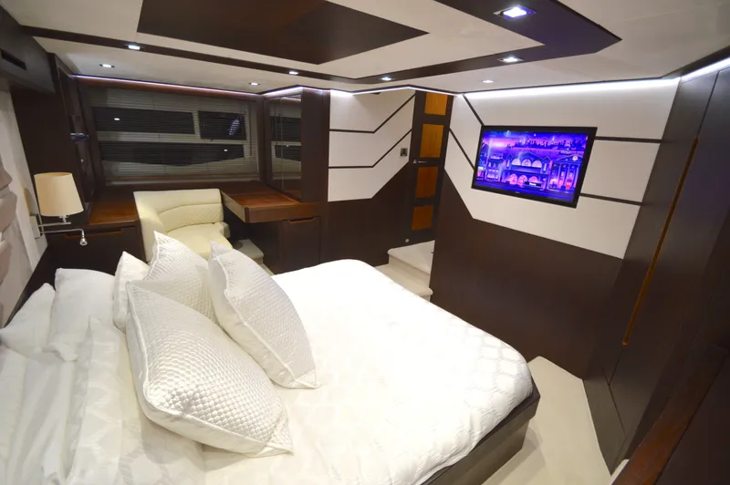 Slide: The Image of Luxurious cabin of the 2016 Galeon 550 Fly with a double bed and flat-screen TV. - 49