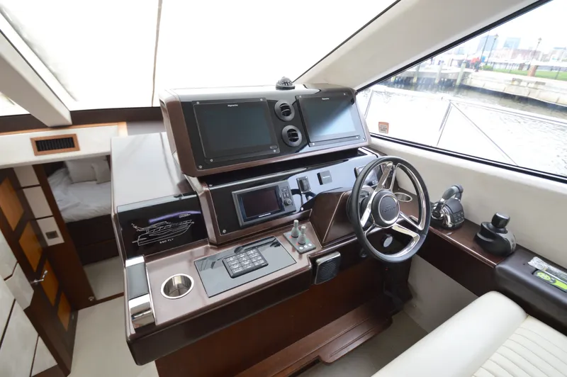 Slide: The Image of The image shows the helm of a 2016 Galeon 550 Fly with modern electronics. - 41