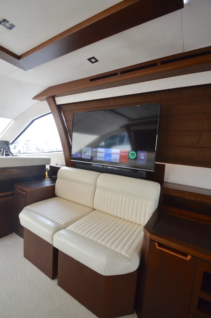 Slide: The Image of Interior of the 2016 Galeon 550 Fly with beige sofa and large flat-screen TV. - 36