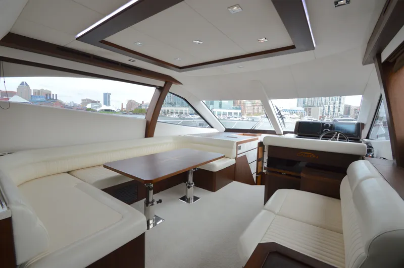 Slide: The Image of Interior of the 2016 Galeon 550 Fly with elegant seating area and panoramic windows. - 33