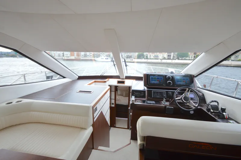 Slide: The Image of Interior of the 2016 Galeon 550 Fly with modern helm and panoramic windows. - 39