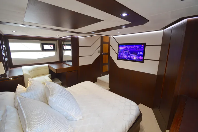 Slide: The Image of Luxurious cabin with a double bed, wood accents, and a flat-screen TV on the wall. - 48