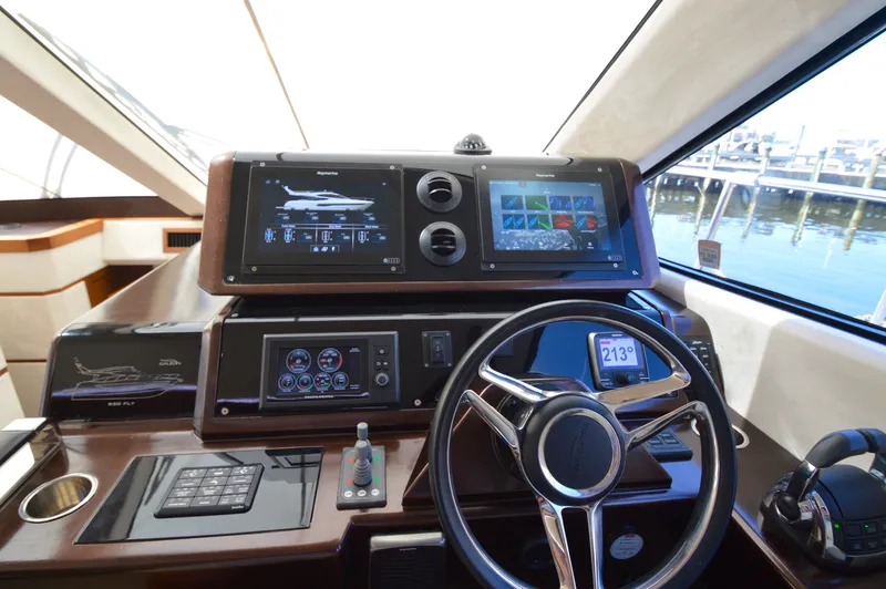 Slide: The Image of The image shows the helm of a 2016 Galeon 550 Fly with modern navigation systems. - 44