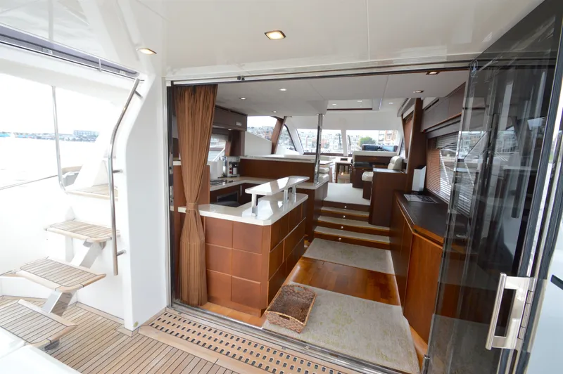 Slide: The Image of The 2016 Galeon 550 Fly features a luxurious interior with wooden floors and modern furnishings. - 21
